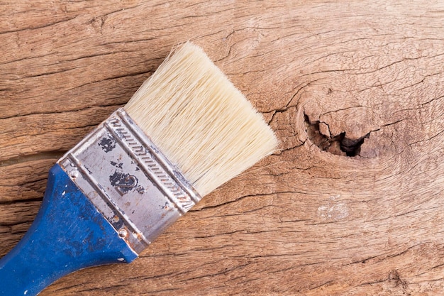 Old paintbrush on wooden background