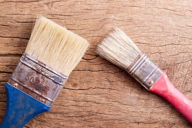 Old paintbrush on wooden background