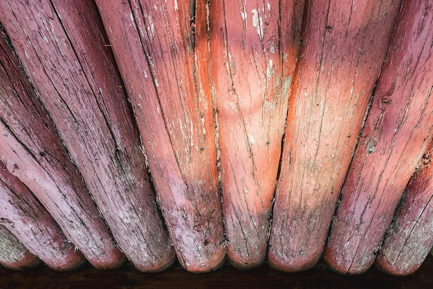 Old painted fence made of round logs