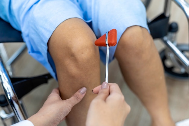 Photo old patient suffering from knee pain at the hospital.