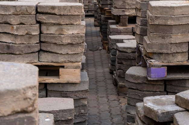 Old paving slabs in closeup Storage of paving slabs during the repair of roads and pedestrian areas Reconstruction of urban infrastructure