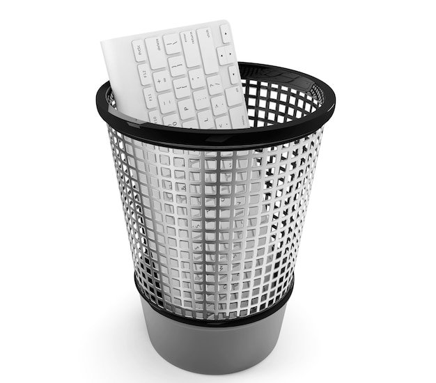 Old PC keyboard in metal trash bin on a white background