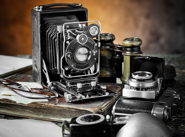 Old photo camera on an old background.
