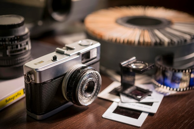 Old photo camera with blurred slide projector in the background