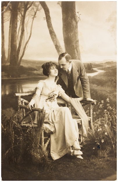 old photo  of young romantic couple of woman and man in spring garden.