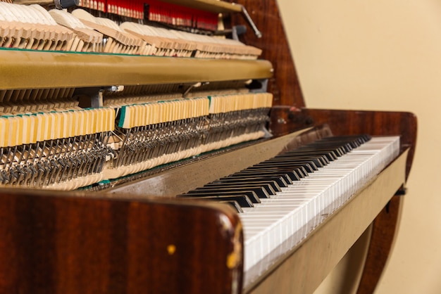 Old piano isolated at wall