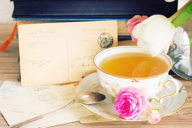 Old pile of  mail with antique cup of tea