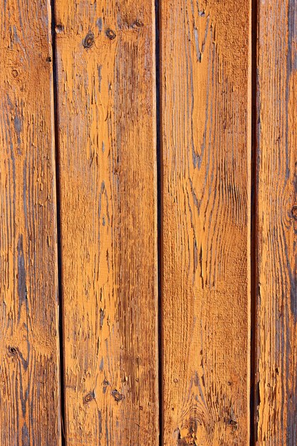 Old plank background with peeling, cracked paint, painted in terracotta color, vertical frame