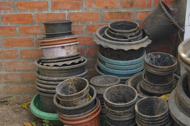 Old plant pots stacked against each other on the wall