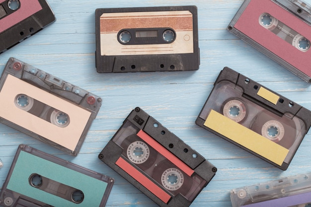 Old plastic cassette on blue wooden. Retro music concept