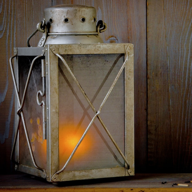 old portable lamp with a burning candle