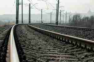 Photo old railroad rails and poles with wires