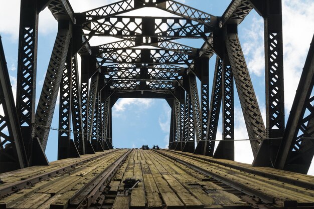 old railway bridge against sky during sunny day