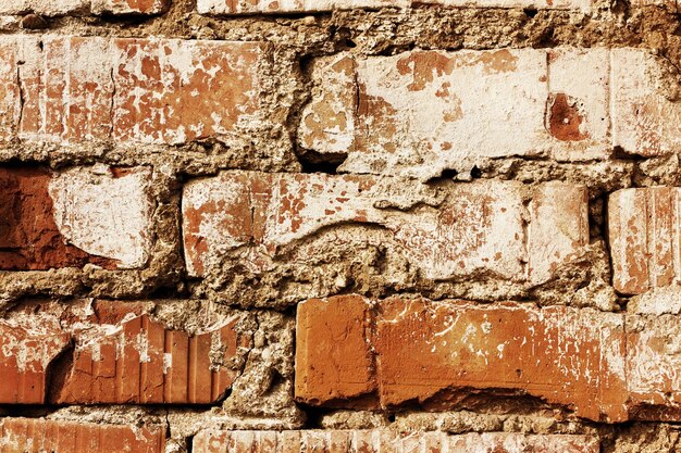 old red brick wall with cracks and scuffs style loft background vintage toning