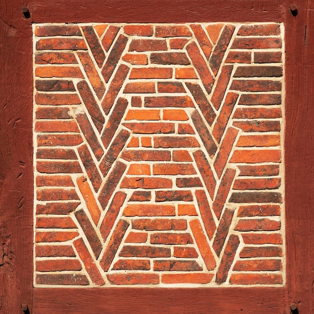 Old red brick wall with wooden beams as texture or background Architectural detail