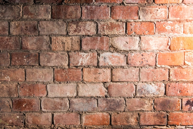 old red brickwork wall with cement 