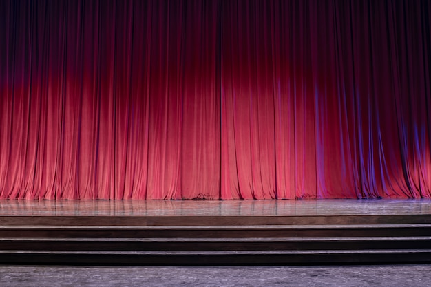 Old red curtains on stage.