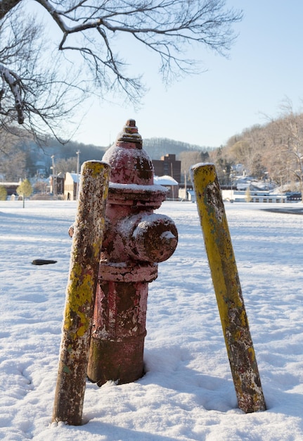 Old red fire hydrant in snow in winter