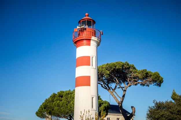 Old red lighthouse in La Rochelle harbor, France