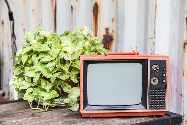 the old red television on wood table