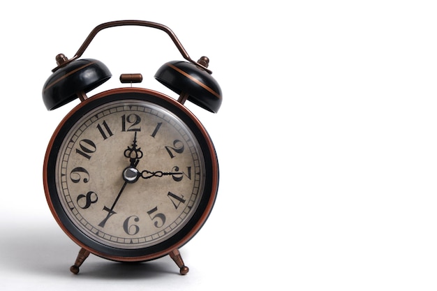 Old retro alarm clock in brown on white background