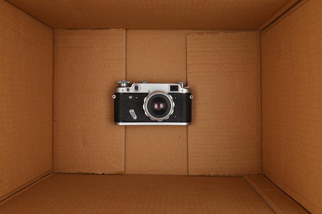 Old retro camera at the bottom of the box