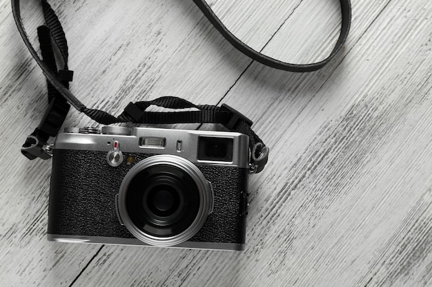 Old retro camera on wooden background