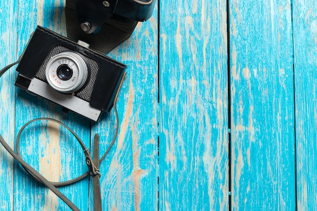 Old retro camera on wooden table 