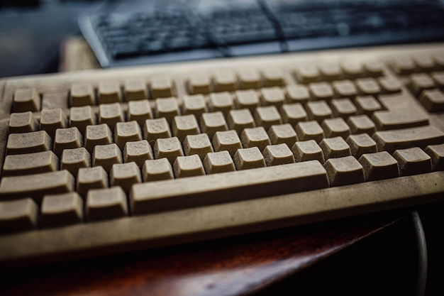 old retro computer keyboard in the dust