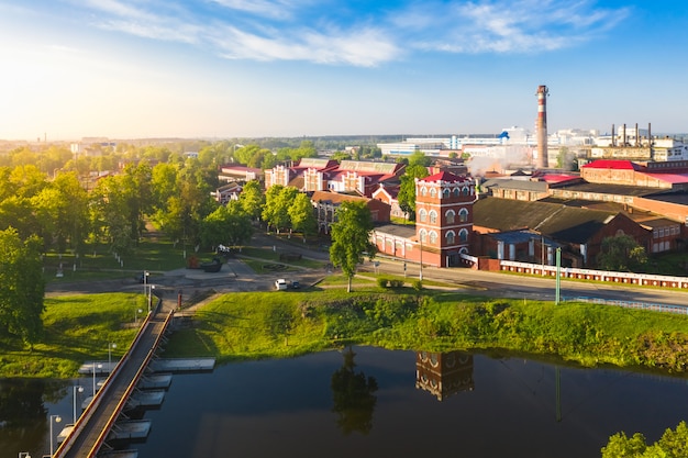 Old retro paper factory in the city on the river