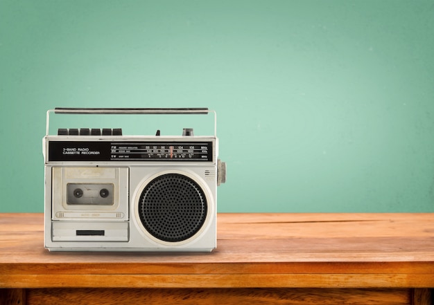 Photo old retro radio on table with vintage green eye light background