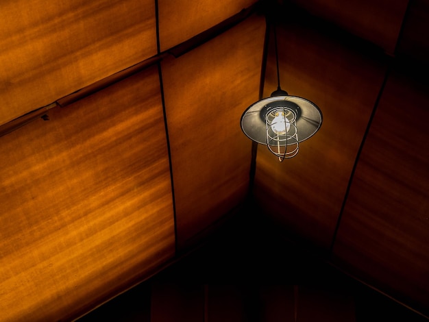 Old retro style lamp hanging on the ceiling inside the large glamping tent at a night with copy space Lighting in the tent