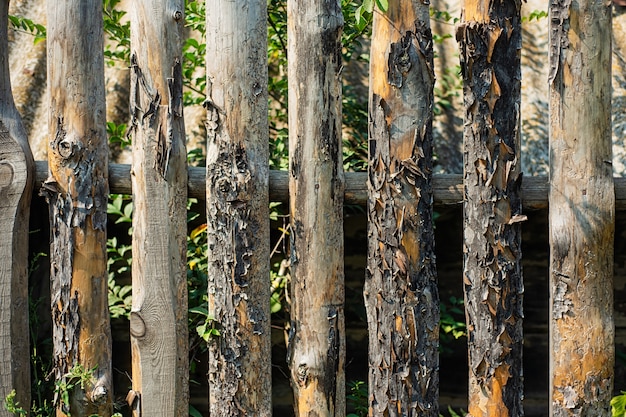 Old rotten fence enclosing the garden. texture of the boards