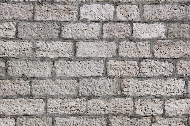 Old rough stone block wall background.