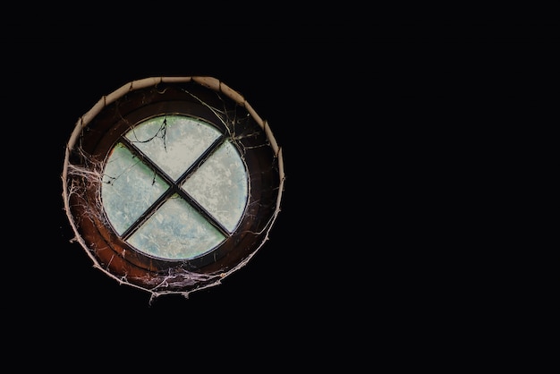 Old round window in the attic, inside view