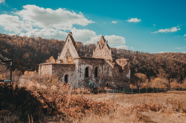 Old ruined fortress in the woods Blue sky with white clouds Beautiful picture for puzzles