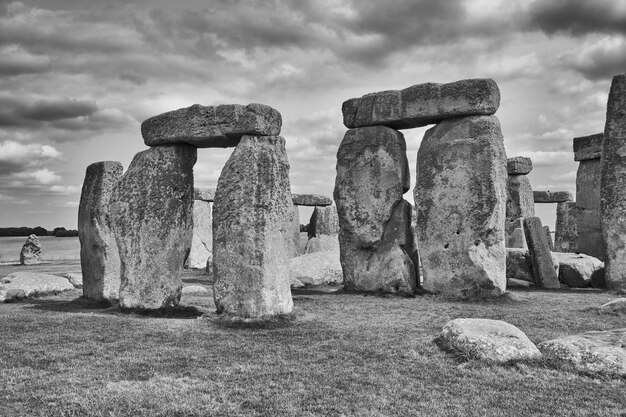 Old ruins on field against cloudy sky