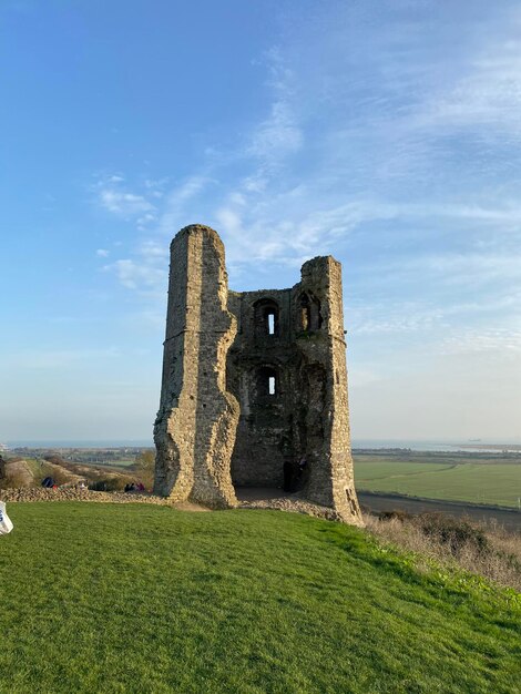 Old ruins on field against sky