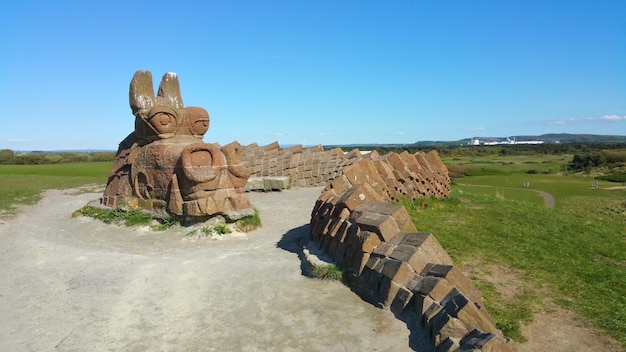 Old ruins on landscape against clear blue sky