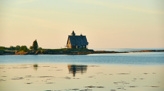 Old run down wooden Saint Nicholas chapel in rural remote natural place , Russia, Karelia, White Sea, near Kem