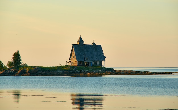 Old run down wooden saint nicholas chapel in rural remote\
natural place , russia, karelia, white sea, near kem