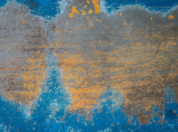 Old rust textured marks on blue steel plates background.