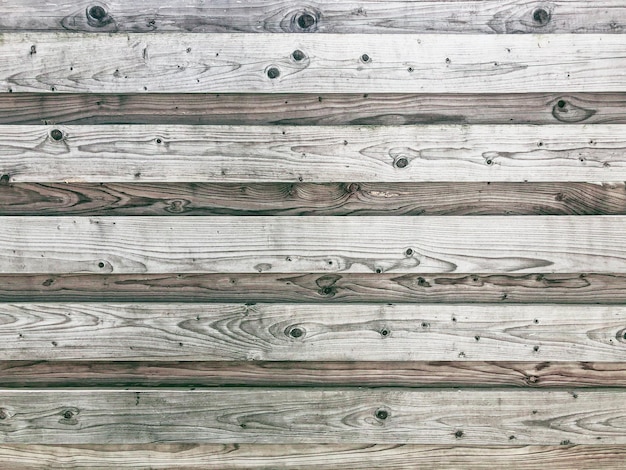 Old rustic fence with wooden texture for background in horizontal position.