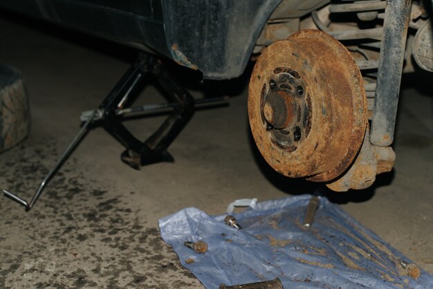 Old rusty car rear brakes. Machine is lifted on jack, repair, replacement of malfunction.