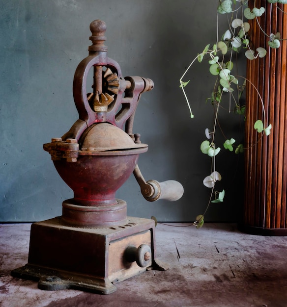 Old rusty coffee grinder. Dark background