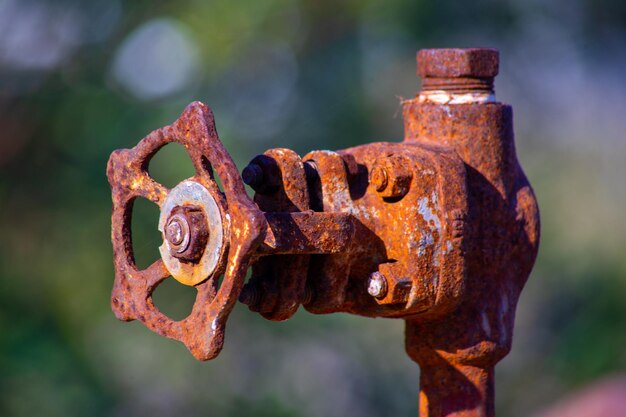 old and rusty faucet of obsolete chemical industrial equipment