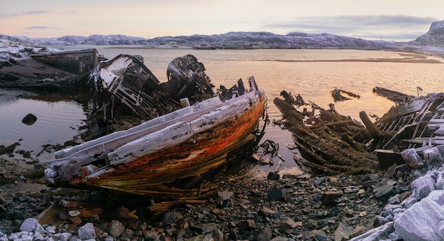 Old rusty fishing boat abandoned by a storm on the shore Graveyard of ships