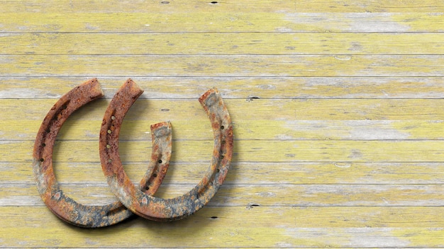 Old rusty horseshoes set on wooden surface