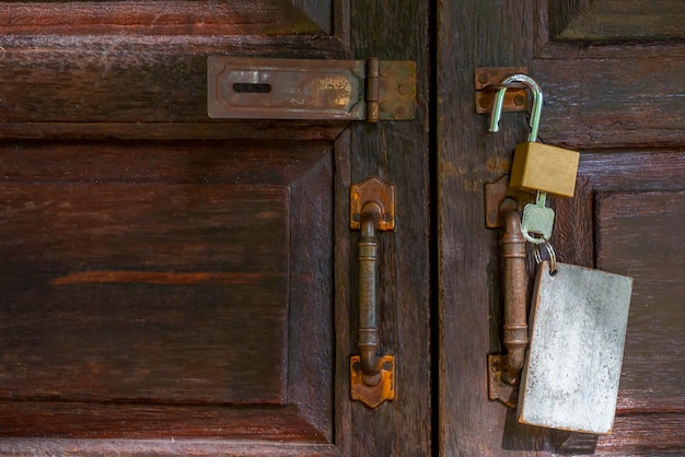 Old rusty and key locks on wooden door