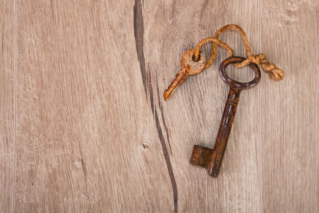 Old rusty keys on wood